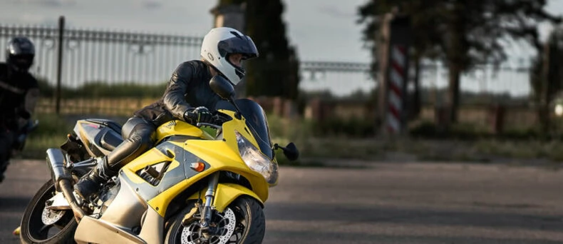 A young woman rides a sport bike - cheap motorcycle insurance in Georgia.