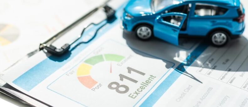Blue toy car on a credit score document - Cheap car insurance in Georgia