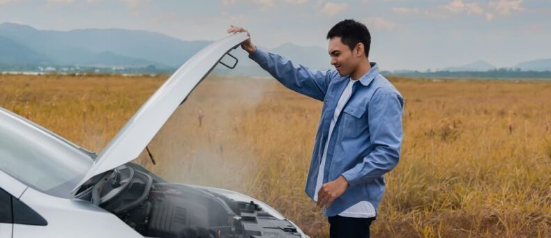 Man opens car hood because it is overheated - Southern Harvest Cheap homeowners in Georgia.