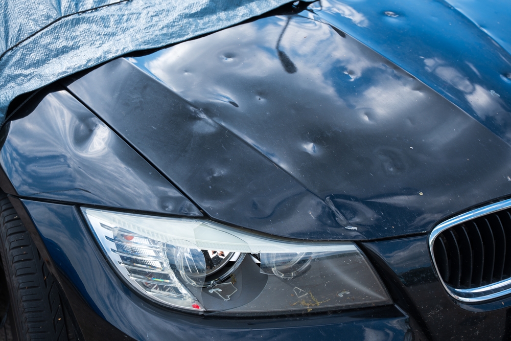 hail damage on the car, with damaged bonnet and headlight