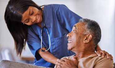 Help, support and wheelchair with nurse and old man for disability, rehabilitation or healing. Retirement, physiotherapy and healthcare with patient and black woman nursing home for medical caregiver, concept of long-term care life insurance.