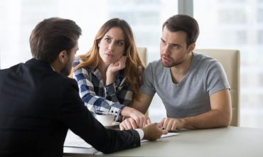 Upset couple discussing their rental dispute with a lawyer, seeking guidance on breaking a lease in Georgia
