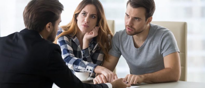 Upset couple discussing their rental dispute with a lawyer, seeking guidance on breaking a lease in Georgia