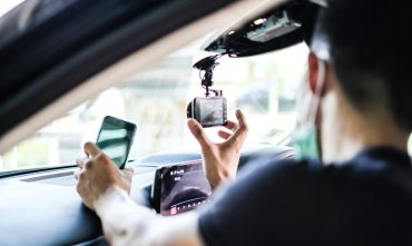 man installing his car cam and understand all of the dashcam benefits.