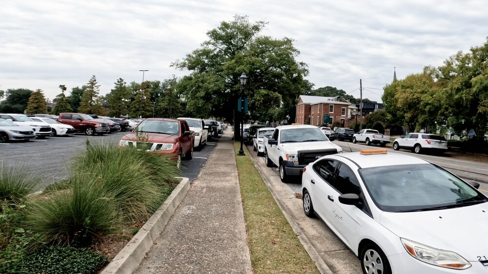 Cars parked along a Georgia street, representing drivers checking their Georgia auto insurance status.