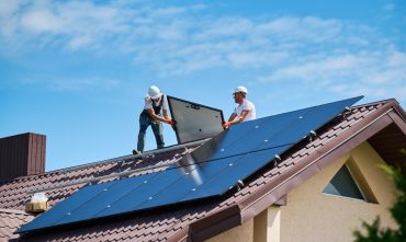 Home insurance for a house with rooftop solar panels being installed.