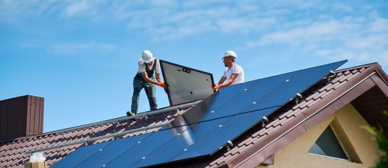 Home insurance for a house with rooftop solar panels being installed.