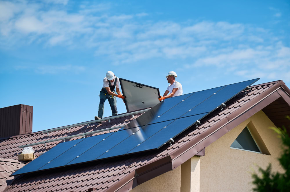 Home insurance for a house with rooftop solar panels being installed.