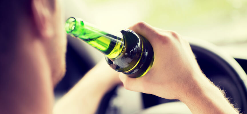 Male driver drinking alcohol