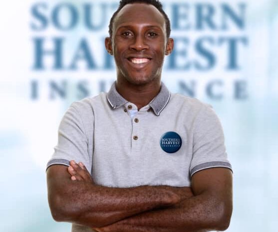 Portrait of smiling african american male southern harvest agent with brand logo in the brackground