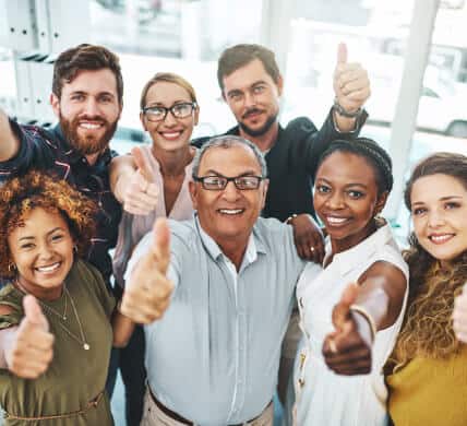 Group shot of smiling and diverse employees in office