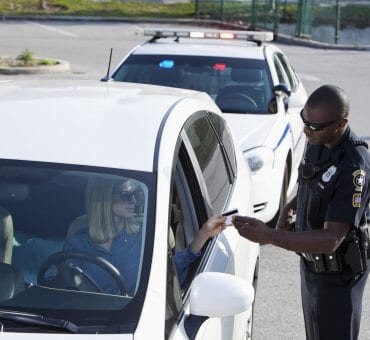 Cop asking for female driver's license on white car pulled over