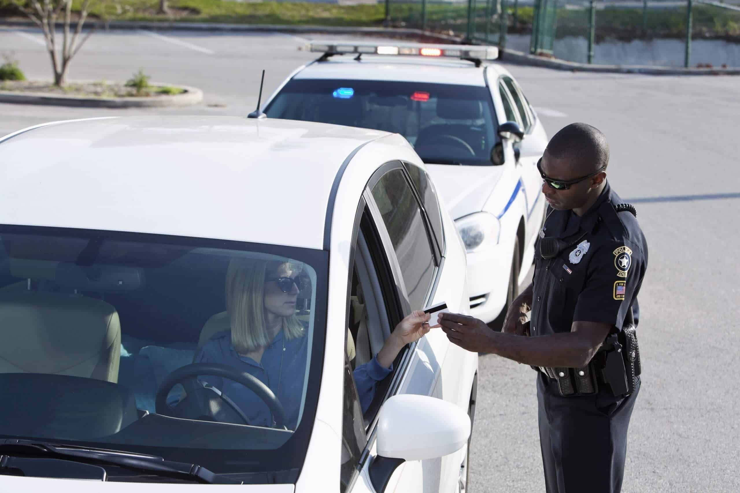 Cop asking for female driver's license on white car pulled over