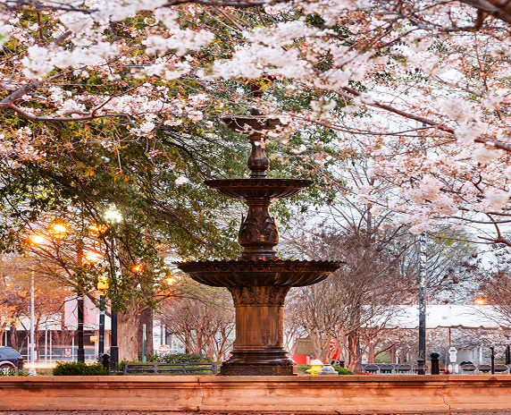 Macon, Georgia, USA downtown square in spring season with the fountain -cheap car insurance in Georgia.