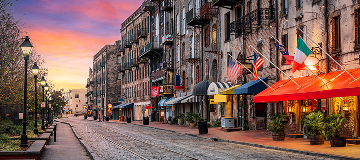 Savannah, Georgia, USA bars and restaurants on River Street at dawn.