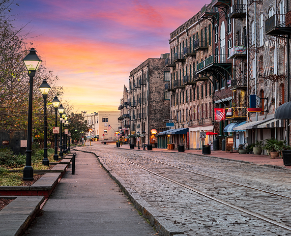 Savannah, Georgia, USA bars and restaurants on River Street at dawn.