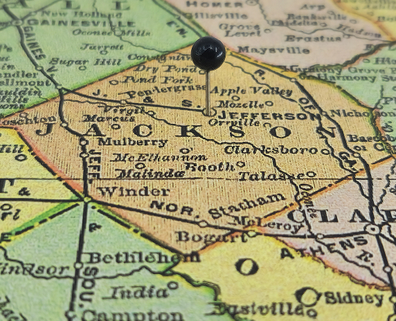 Jackson County, Georgia marked by a black tack on a colorful vintage map. The county seat is located in the city of Jefferson - cheap car insurance in Georgia.