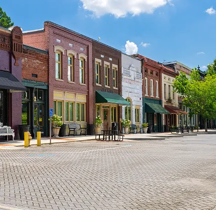 A main street in a small rural town in the USA, near Sugar Hill, Georgia. Image taken on July 28, 2025. Cheap car insurance in Georgia.