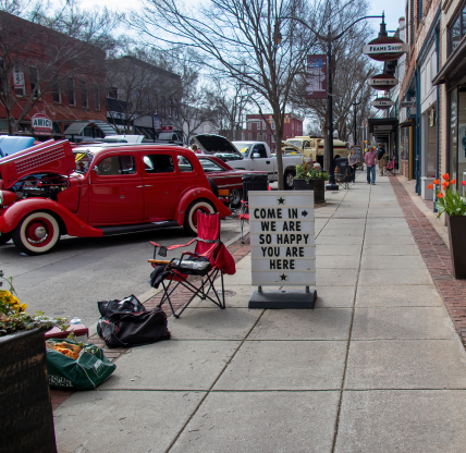 Monroe, Georgia - March 14, 2020: A sign on the street outside of a retail shop welcomes visitors during the 15th Annual Memories in Monroe Car Show.